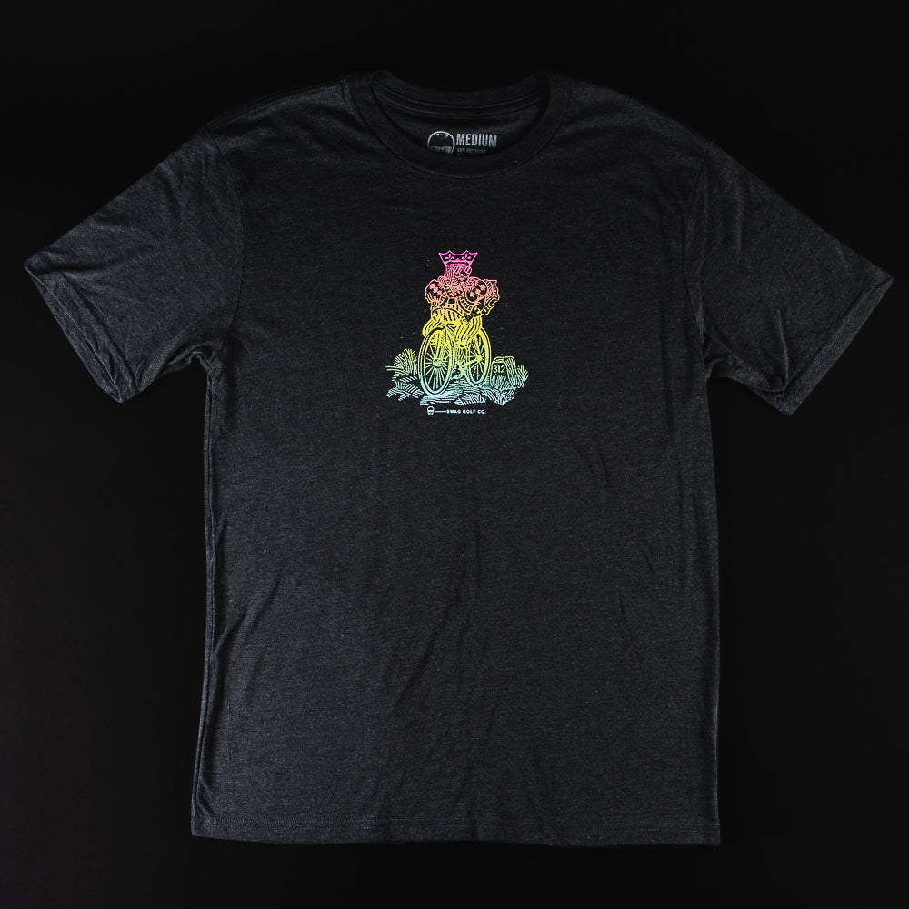 Swag Golf black t-shirt with rainbow colored graphic of a king riding a bicycle.