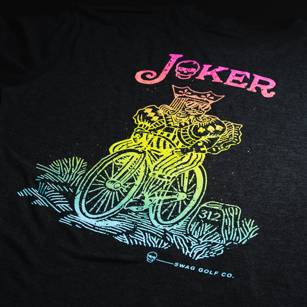 Swag Golf black t-shirt with rainbow colored graphic of a king riding a bicycle.