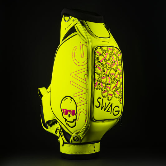 Swag x Vessel tour staff neon yellow golf club bag with stacked pink skulls.