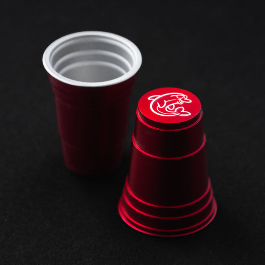 Red flip cup aluminum golf ball marker accessory with dolphin design made in the USA.