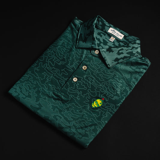 Swag x Peter Millar Augusta yellow embroidered skull on green camo print men's short sleeve golf polo shirt.